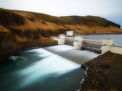 water flowing over a dam